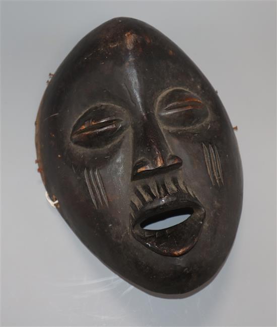 An African Makonde carved hardwood mask length 30cm